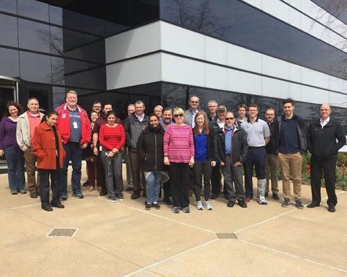St. Louis employees pose for a group photo outside the office